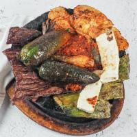 Molcajete · chicken breast, one steak, 6 shrimps, chorizo, grilled fresh cheese, nopales, 2 cambray onio...