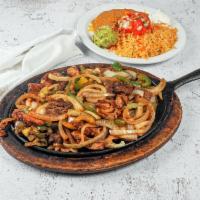 Fajita Borracha · Beef, chicken and shrimp, cooked in beer, onion, bell pepper, served with rice, beans, guaca...