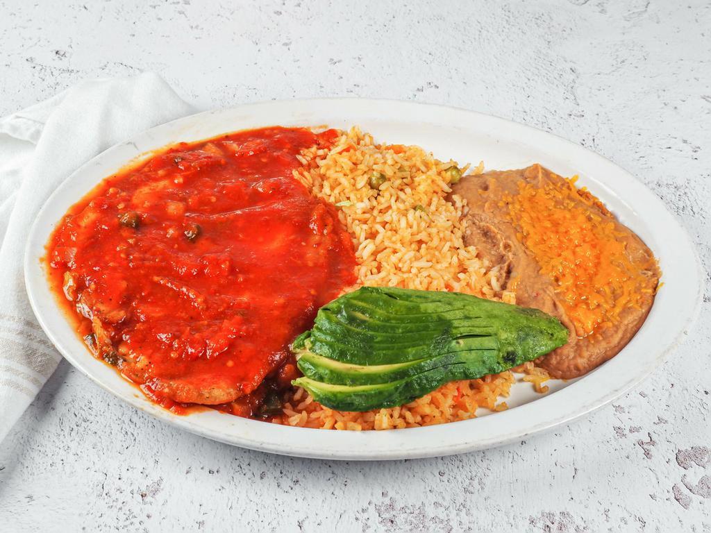 Pescado a la Diabla · Served with rice and beans.