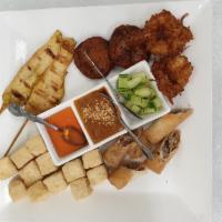 CoCurry's Sampler · A Combination of chicken satay, fish cake, coconut shrimp, crispy tofu and veggie rolls