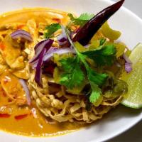 Khao Soi  · Curry egg noodles special curry with egg noodles served with red onion and pickled mustard a...