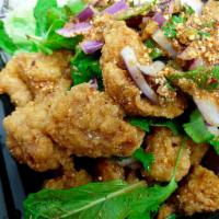 Crispy Chicken Larb Salad · Battered tender chicken and Thai herbs, roast rice powder with spicy lime sauce.