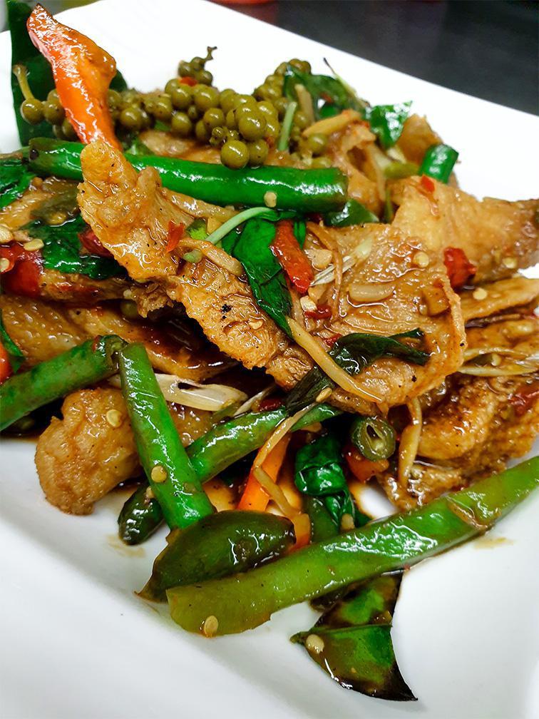 Pad Cha Catfish · Deep-fried catfish fillet, sauteed in spicy homemade curry paste with basil, wild ginger, green bean, bell pepper, pepper-corn and kaffir lime leaves.