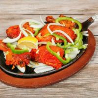67. Tandoori Chicken · Skinless chicken legs and breast marinated in yogurt with spices and barbequed.