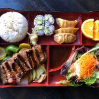 Angus Beef Teriyaki Bento Box · Comes with Salad, California Roll, Gyoza, Fruit, and Rice.