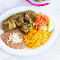 Costillas de Puerco Dinner · Pork ribs in green or red sauce. Served with a side of rice, beans and salad. 6 tortillas in...
