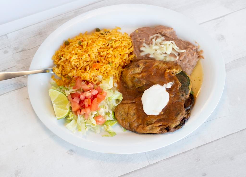 Chiles Rellenos Dinner · Two stuffed poblano peppers topped with our special red sauce. Served with a side of rice, beans and salad. 6 tortillas included.