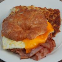 Breakfast Croissant · Fresh baked croissant, ham, eggs, cheese, hash browns or fruit.