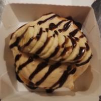 Elvis Roll · Peanut butter frosting: topped with freshly sliced bananas and chocolate sauce