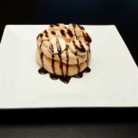 Peanut Butter Cup Roll · Peanut butter frosting, chocolate chips and chocolate sauce.