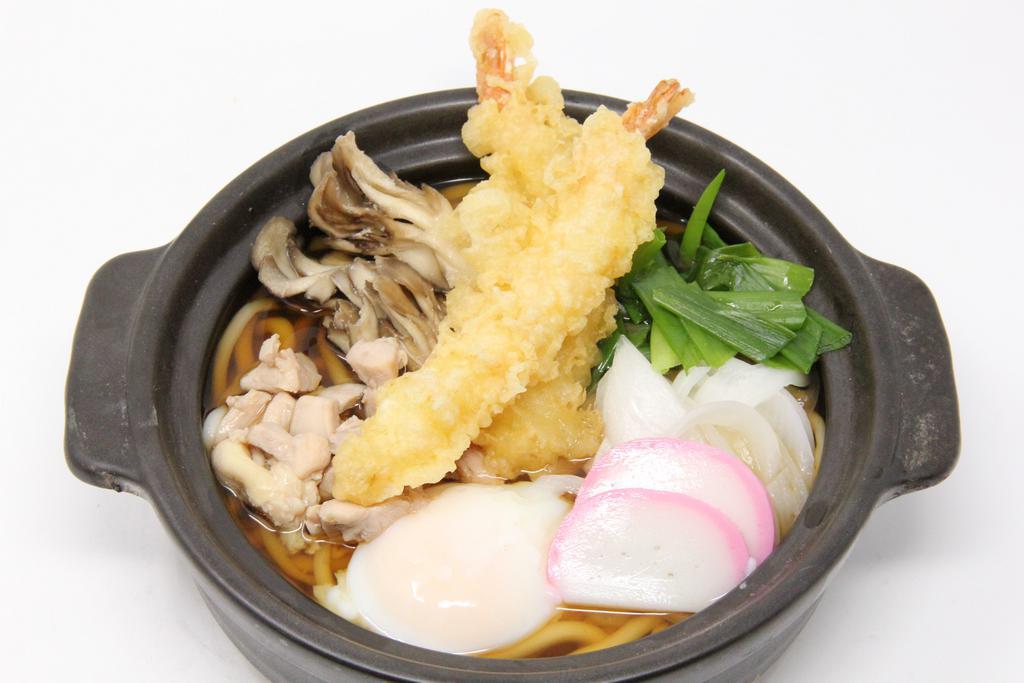 Nabe Yaki Udon · Shrimp tempura, chicken, onions, fish cake, maitake, green onions cooked in clay pot.