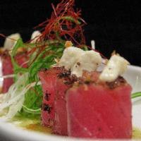 Blackened Tuna with Goat Cheese · Seared peppercorn tuna drizzled with wasabi honey sauce and topped with goat cheese.