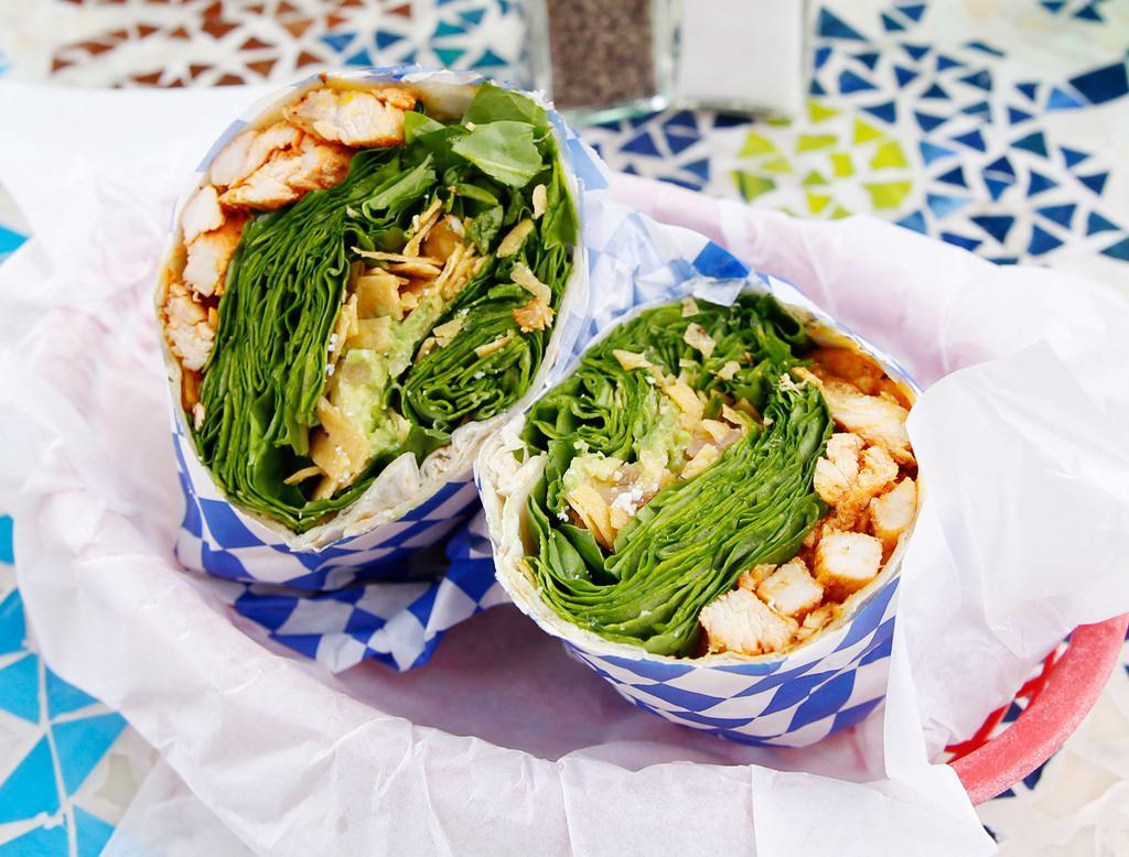 Spinach Chicken Burrito · Fresh baby spinach tossed in signature rosemary-lime vinaigrette, grilled chicken, sliced avocado, crispy tortilla strips and Cotija cheese.