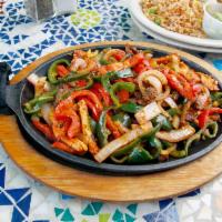 Fajitas Platter · A choice of protein served with fresh red onions, red bell peppers and poblano peppers. Serv...