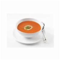 Tomato Soup · A delicious light creamy tomato soup flavored with herbs, garnished with basil and cream.