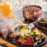 Sizzling Tandoori Platter · Sizzling tandoori platter an assortment of tandoori chicken, chicken tikka, sheek kabab, lam...