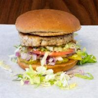 Turkey Burger · Turkey Burger topped with lettuce, tomato, red onion, & pickles on a wheat bun.