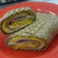 Omelet Wrap · Two eggs, cheese with your choice of bacon, ham or sausage on a wheat wrap