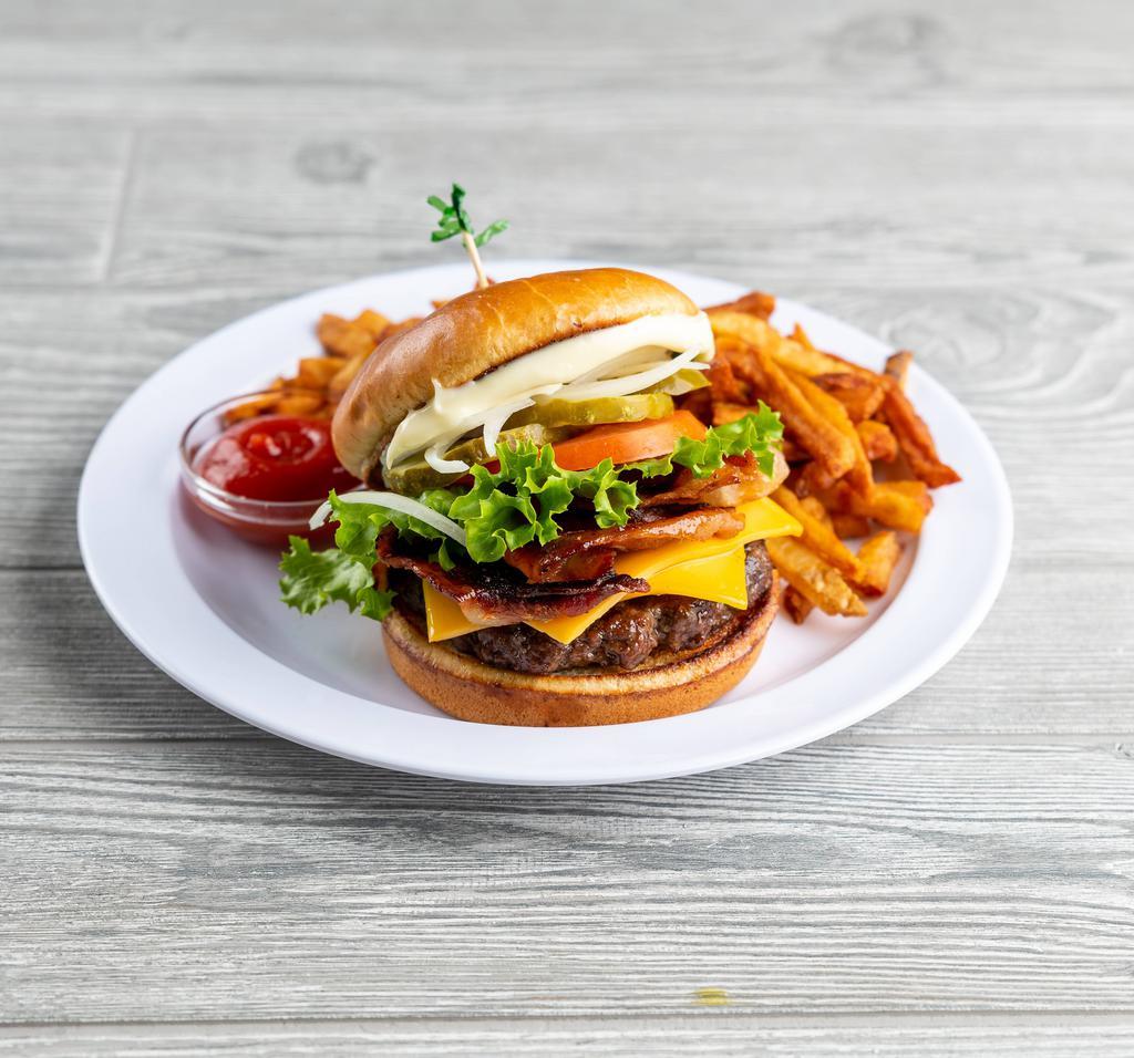 Bacon Cheeseburger · Beef, bacon, lettuce, tomato, onion, pickles and American cheese. Burger grilled to a medium-well unless otherwise specified. Burgers are 100% ground rib eye and served on a brioche bun. Served with side.