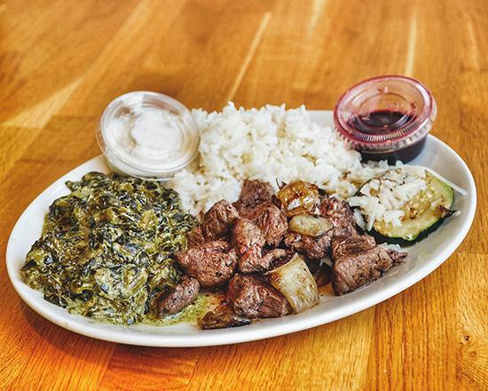 Steak Plate · Filet tips, caramelized onion, zucchini, rice, creamed kale and spinach, red wine glaze and horseradish cream sauce.