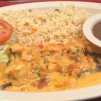 Mar y Tierra Specialty · Steak and shrimp cooked in cream sauce. Served with rice, beans, salad, and two tortillas.