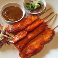 04. Four Chicken Satay · Grilled and marinated chicken on skewers. Served with peanut sauce. 