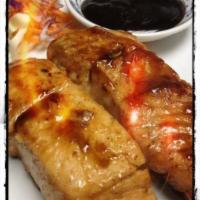 07. Two Grilled Salmon · Salmon on skewers marinated with teriyaki sauce and spices, grilled to perfection.