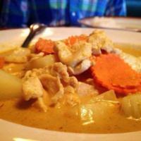 26. Yellow Curry · Yellow curry soup with potatoes, carrots, onions, coconut milk, palm sugar and your choice o...