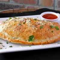 Cheese Calzone · Ricotta, mozzarella and parmigiano served with a side of sauce.