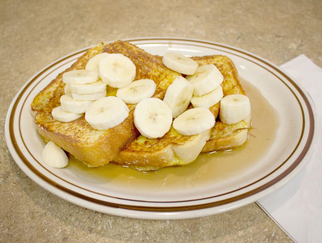Bahama Rum French Toast · 3 slices of thick Texas bread grilled in egg batter, topped with bananas and our homemade rum syrup and butter.