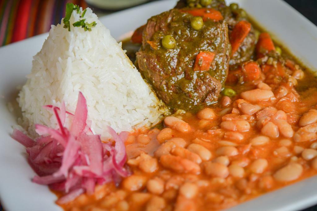Seco de Carne con Frejoles · 8 oz. Tender cuts certified Angus beef braised in a cilantro and Peruvian sauce. Served with canary beans and jasmine rice.