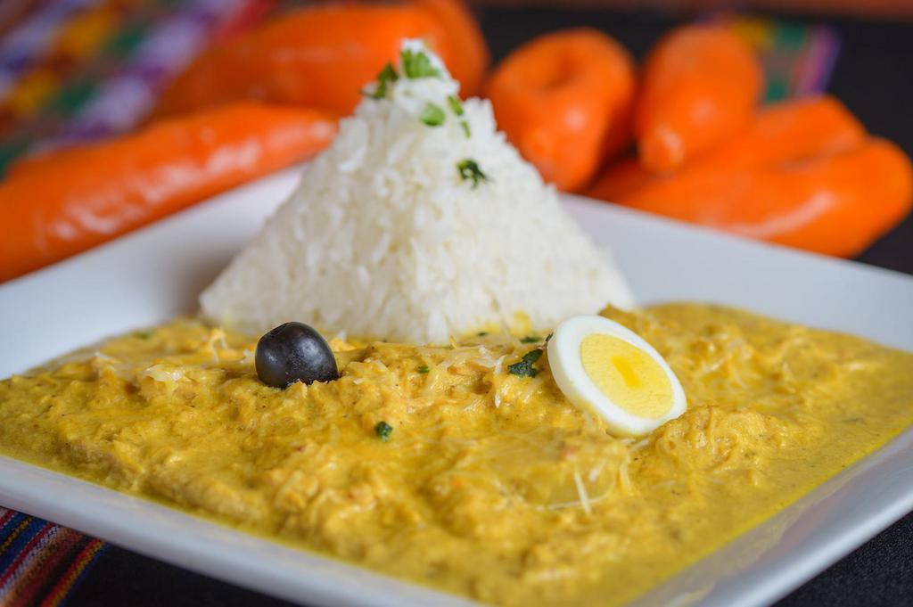 Tray - Aji de Gallina · Tray of Prime pulled chicken breast, cooked in Aji Amarillo and roasted walnuts, served over sliced boiled potatoes. Served with jasmine rice.