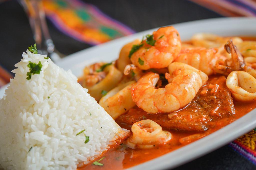 Pescado a lo Macho · Pan-seared, fresh white fish fillet with an assortment of seafood, and braised in a rocoto pepper suave sauce served with jasmine rice.