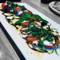 Caprese Salad · Fresh mozzarella, tomatoes and basil drizzled with garlic herb oil and balsamic reduction. V...