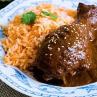Mole pobla · Chicken in mole sauce with rice and beans