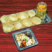 Pani Puri · Puffed crispy wheat shells stuffed with potato, chickpeas topped with tamarind chutney and s...