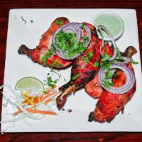 Tandoori Chicken · Chicken cooked with authentic herbs and spices in clay oven. *Punjab Special*