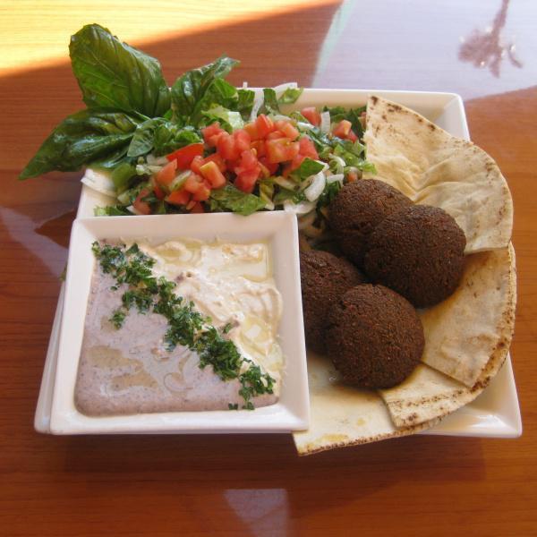 Falafel Plate · Home-made from scratch. Falafel with side of Mediterranean salad. Served with black bean hummus and tahini sauce. Accompanied with pita bread.