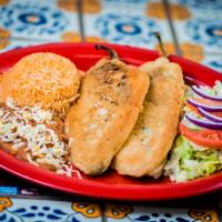 Chiles Rellenos · 2 stuffed chiles rellenos with cheese served with rice, beans and salad.
