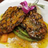 Grilled pork Chops · Dipped in passion fruit sauce with yucca mash.