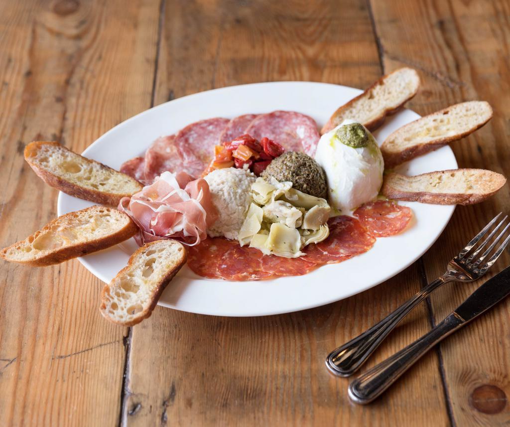 Antipasta Plate · Olive tapenade, cannellini bean dip, marinated artichoke hearts, salami, soppressata, prosciutto, buffalo mozzarella and Mama Lil’s peppers, served with a toasted Grand Central Bakery baguette.