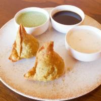 Vege Samosa · 2 pieces. Crispy turnover stuffed with potatoes, green peas, spinach, and fresh Indian spices.