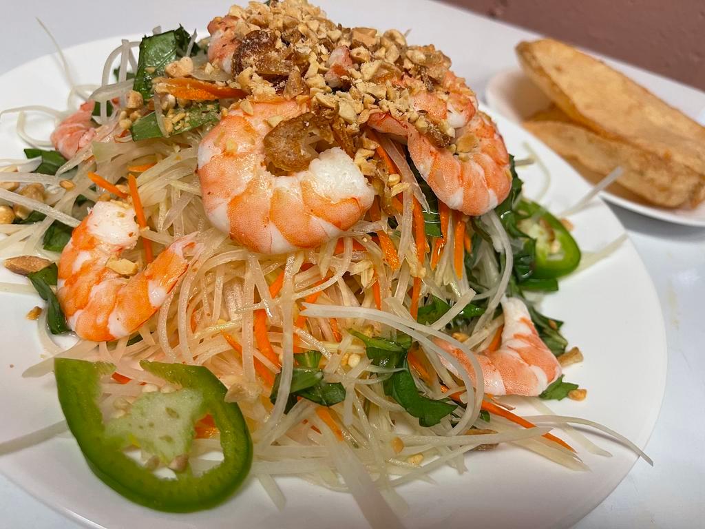 6. Green Papaya Salad · Goi du du. shredded green papaya, tossed with basil and house made sauce topped with dried onion and toasted peanuts served with two shrimp chips