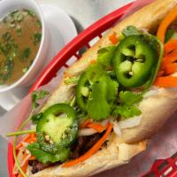 10. Banh Mi · French bread sandwich. Served with cucumber, cilantro, pickled carrots and radish, and jalap...