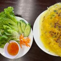 11. Vietnamese Pancake · Banh xeo cooked crispy with shrimp, pork, mung bean, bean sprouts, comes with lettuce, mint,...