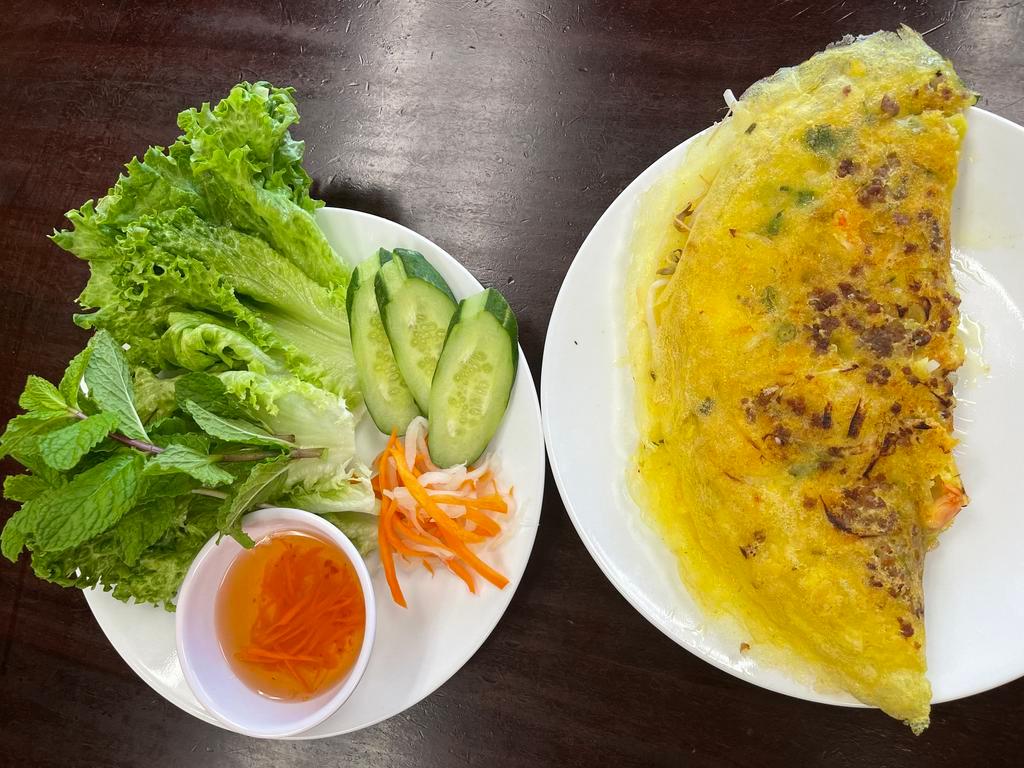 11. Vietnamese Pancake · Banh xeo cooked crispy with shrimp, pork, mung bean, bean sprouts, comes with lettuce, mint, cucumber, pickled veggies, and house made sauce.