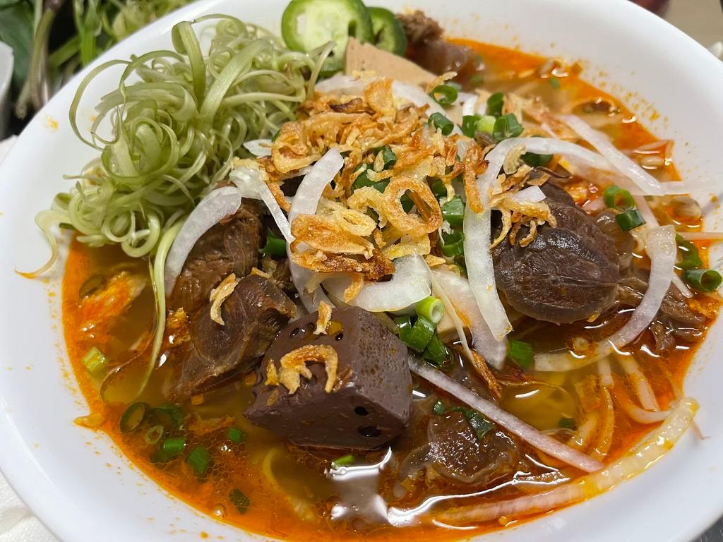 12. Spicy Beef Soup · Bun bo hue. Spicy beef broth with steamed pork, beef shank, tendon, pig blood, herbs, bean sprouts, onions, mint, and vermicelli noodles.