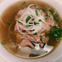 19. Rare Steak Pho · Top quality ribeye meat served over bed of pho noodles topped off with white and green onion.