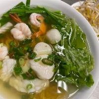 36. Special Seafood  Noodle Soup · Egg noodles, topped with fish balls, shrimp, squid, scallops, and onion flakes.
