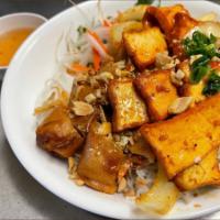47. Lemongrass Tofu and Vegetarian Spring roll Vermicelli · Lemongrass tofu and vegetarian spring roll served over a bed of vermicelli noodles, lettuce,...